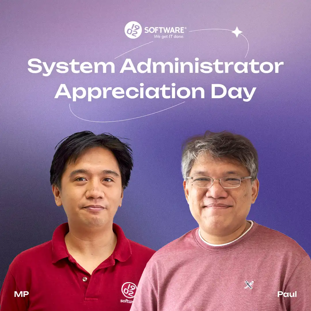 System Administrator Appreciation Day text with two men standing side by side, one wearing a red 1902 Software polo, the other a pink shirt