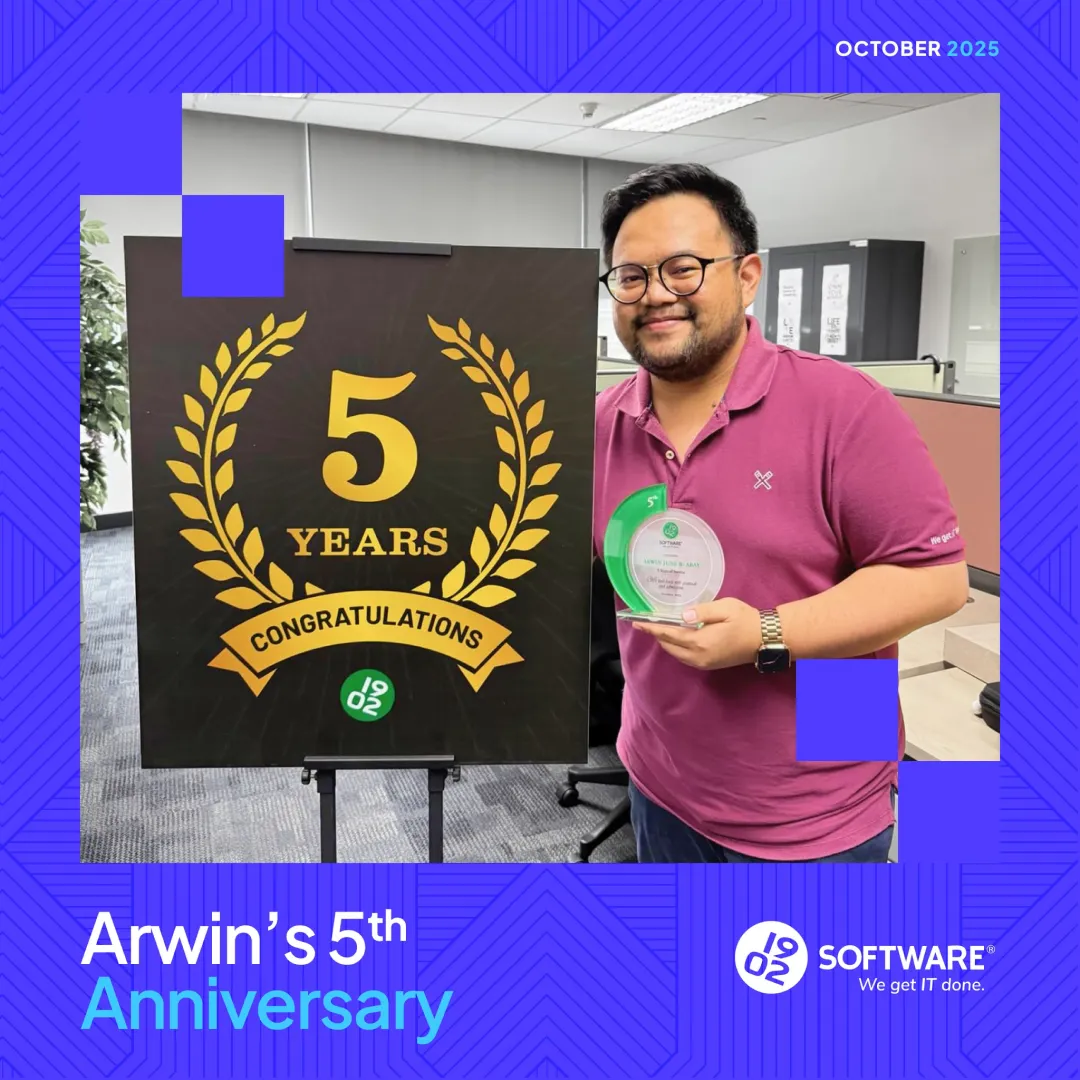 Arwin holding a 5th anniversary award next to a sign reading "5 Years Congratulations" in an office setting, October 2025.