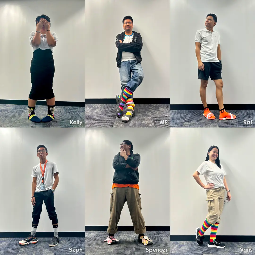 Six team members standing against a white wall showing colorful and mismatched socks, names Kelly, MP, Raf, Seph, Spencer, and Vans visible below each person.